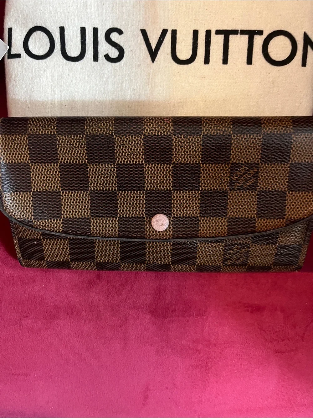 Louis Vuitton Emilie Wallet in Damier Ebène canvas features a sleek flap des